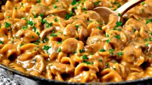 French Onion Pasta mit geschmolzenem Käse und karamellisierten Zwiebeln im großen Topf