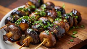 Gegrillte Champignon-Spieße auf dem Grillrost mit goldbrauner Farbe und Grillstreifen