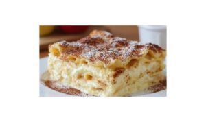 Angeschnittene Apfellasagne mit sichtbaren Schichten aus Äpfeln und Quarkcreme, serviert mit Vanillesoße